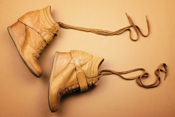 Brown leather boots on a brown background. Flat lay. The view from the top.