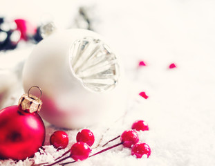 Obraz na płótnie Canvas Christmas decoration, fir-tree glass balls, holidays, new year and decor concept. Closeup New Year's fir-tree toys on a snow surface, soft focus