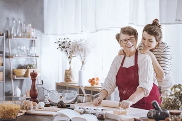 Foto auf Acrylglas Senior woman in kitchen apron © Photographee.eu