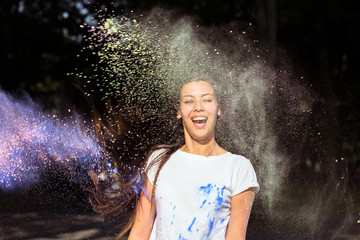 Happy young asian woman in white t shirt celebrating Holi Festival