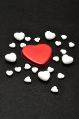 Obraz premium Valentine's Day. A red heart shape displayed on a black background with different size polystyrene hearts