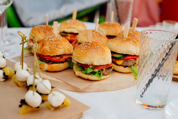 Mini burgers on a tray. Food for a party.