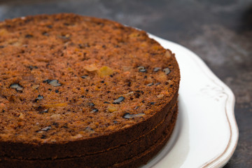 Carrot layer cakes with nuts and pineapple cut with roasted whisk and cream cheese