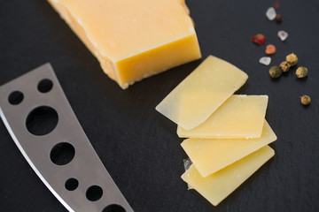 cheese knife with a wooden handle over black