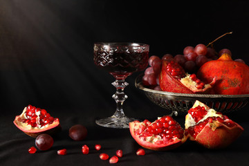 Pomegranate, grapes and a glass of wine