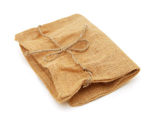 Hessian sack with ties forming over white background.
