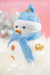 Happy snowman standing in winter christmas snow background. Merry christmas and happy new year greeting card with copy-space. Christmas celebration holiday background.