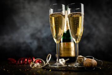 Two champagne glasses in golden glitter