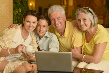 family near table with laptop