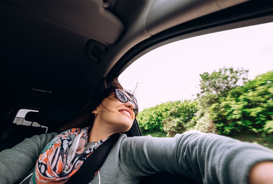 Woman enjoy with view from car window in traveling by auto
