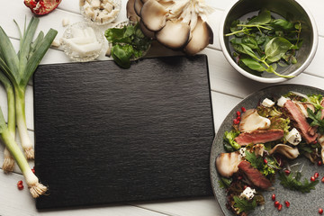 Fototapeta na wymiar Warm mix salad with duck meat and mushrooms. Modern restaurant dish