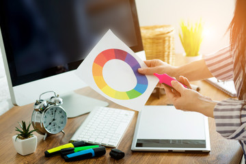 Woman working with color samples for selection. Graphic designer at work.