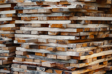 Stack of lumber. Timberwork, lumber work and woodwork industry concept. Close up old wooden timber planks.