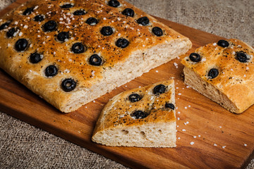 Delicious homemade focaccia. Traditional Italian bread with olives and sea salt