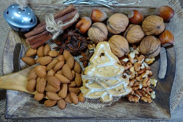 Decorative Christmas cookies, almonds, nuts, cinnamon and anise stars.Christmas sweets and nuts.
 ...