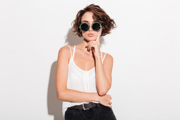 Serious sexy woman wearing sunglasses