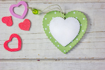 Colored hearts over wooden background - Valentine's day concept