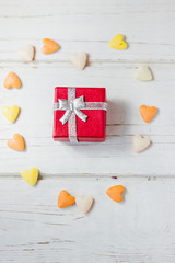 Valentine's day concept - red box with gift on white wooden surface