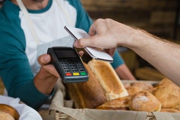 Customer paying bill through smartphone using NFC technology at