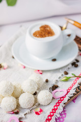 Candy and coffee on bed.