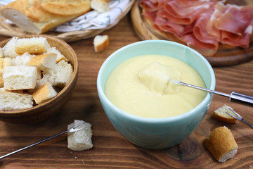 Traditional cheese fondue with baguette
