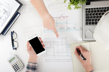 Architects working on blueprint, real estate project. Architect workplace - architectural project,...