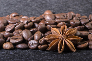 star anise, on the background of coffee with beautiful highlights on the surface of grains