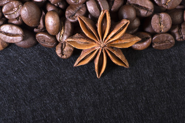 star anise, on the background of coffee with beautiful highlights on the surface of grains
