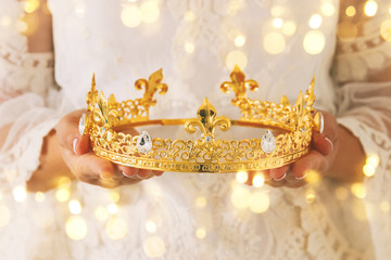image of beautiful lady with white lace dress holding diamond crown. fantasy medieval period.