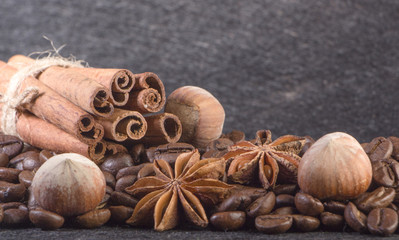 Close-up, roasted coffee seeds, tubberry, cinnamon sticks and chocolate.