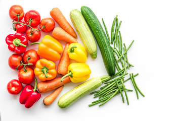 Colorful vegetables for healthy diet. Paprika, tomatoes, carrot, zucchini, eggplant on white background top view