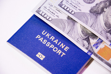 Ukrainian biometric passport and two banknotes for a hundred dollars. Visa-free travel and immigration. Business trips.