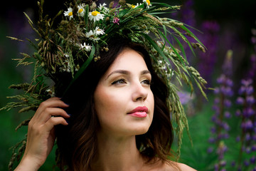 Portrait of a beautiful bride in a white dress and a wreath of F