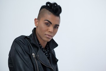 Transgender woman standing against white background