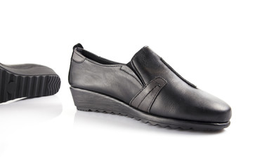 Female black leather shoe on white background, isolated product, comfortable footwear.