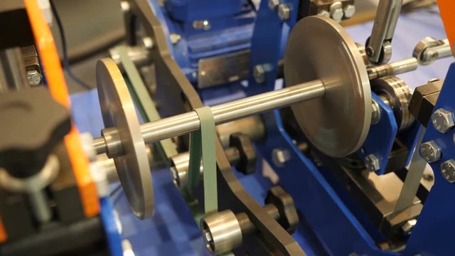Closeup shot of rotating belt gears, side view