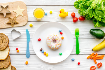 Prepare healthy breakfast for children. Meal with vegetables and fruits. White wooden background top view