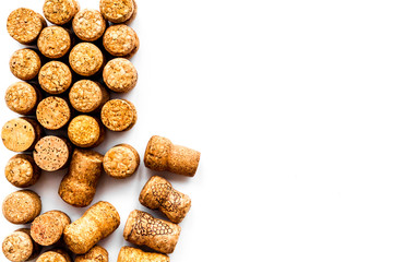 Wine bottle corks pattern on white background top view copyspace. New Year celebration concept