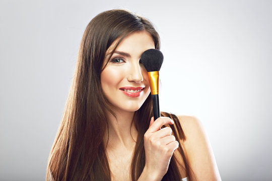 Beautyful woman applying  make up with brush.