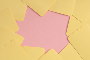 The colorful background from yellow cards and pink paper. Copy space.