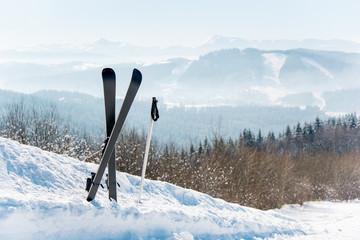 Shot of skis in the snow on top of a mountain copyspace incredible beautiful natural landscape on the background