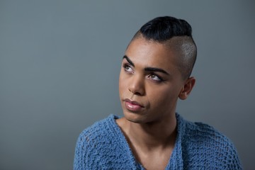 Transgender woman looking away while standing 