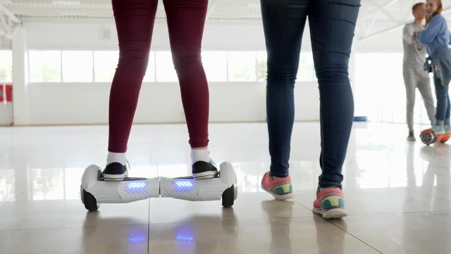 modern technologies, close-up of man's legs on gyroscooter in mall