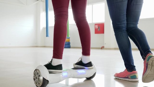 close-up of a man's legs riding on gyroscooter in mall, modern technologies