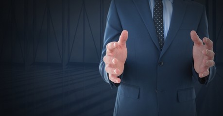 Businessman with hands palm open and dark background