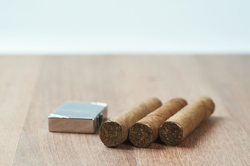 Cigars with a gasoline lighter.