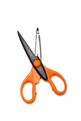 Orange and open scissors on white background