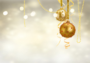 Golden christmas balls garland on glowing silver background