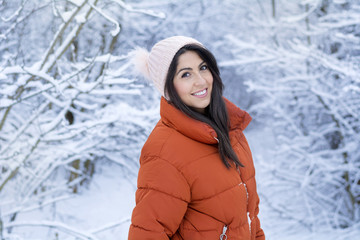 Fototapeta na wymiar Beautiful Smiling Young Woman in a Winter Snowy Forest .Winter Holidays