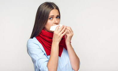 Sick flu woman with red scarf using paper tissue.